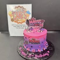 Pink birthday cake with toppers from Kiss Me Cakes