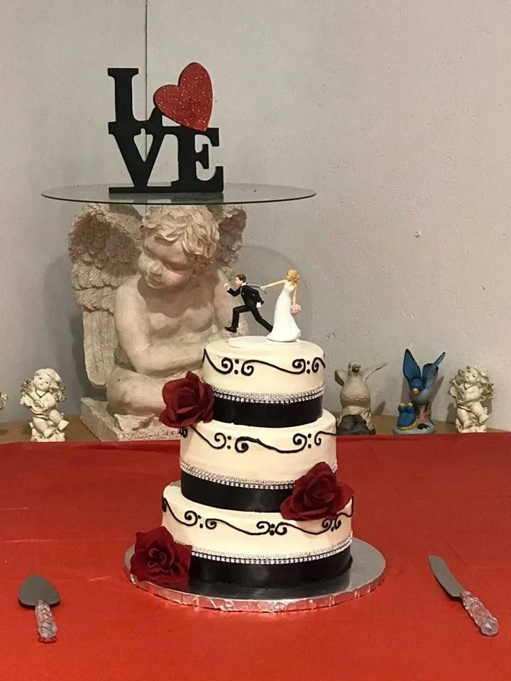Tiered wedding cake with roses from Kiss Me Cakes in Hope Mills