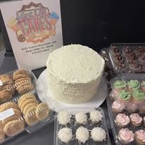 Wedding dessert table with cake cupcakes and cookies from Kiss Me Cakes